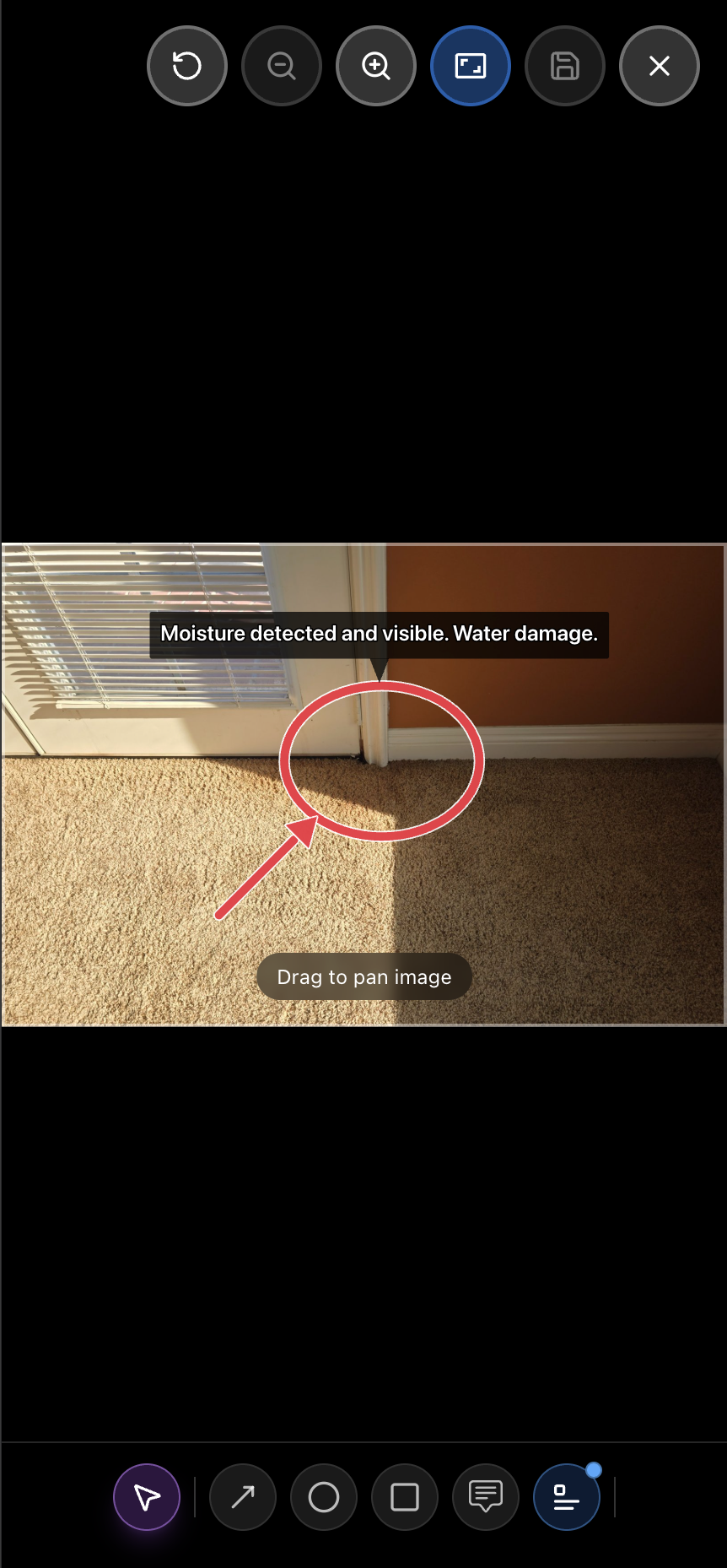 Inspection photo marked up on-site with a red circle and arrow pointing to moisture damage and a text caption reading 'Moisture detected and visible. Water damage.'